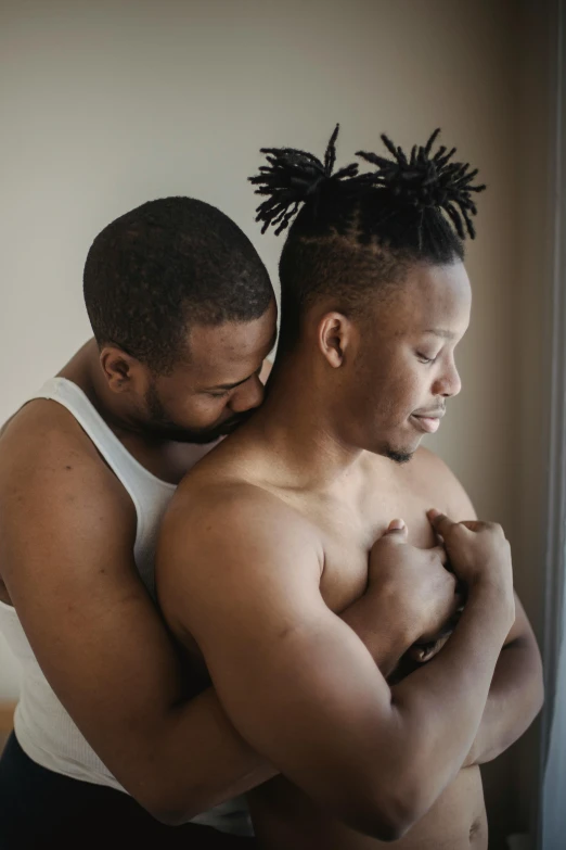 two men are emcing while wearing white shirts