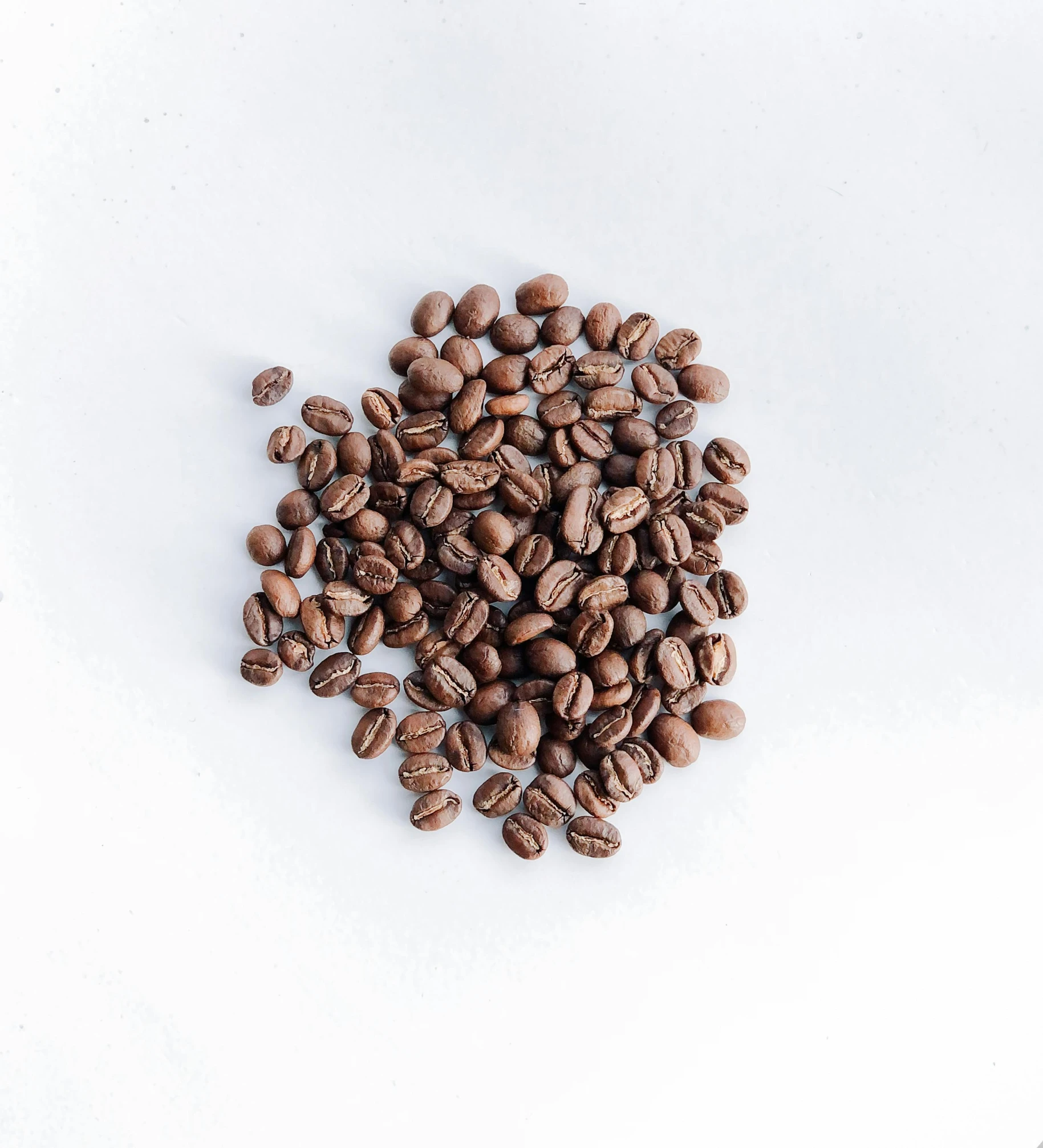 several coffee beans sitting in a pile on top of each other