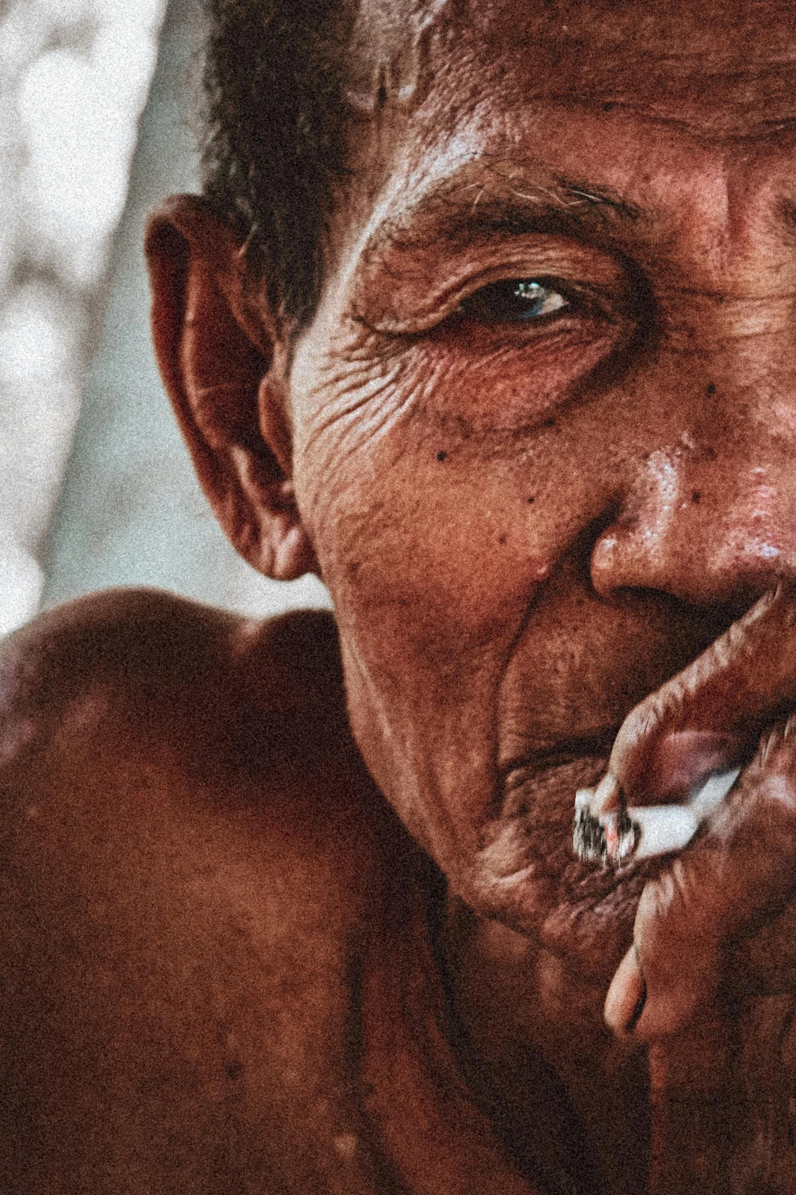 a man smoking a cigarette outside on a sunny day