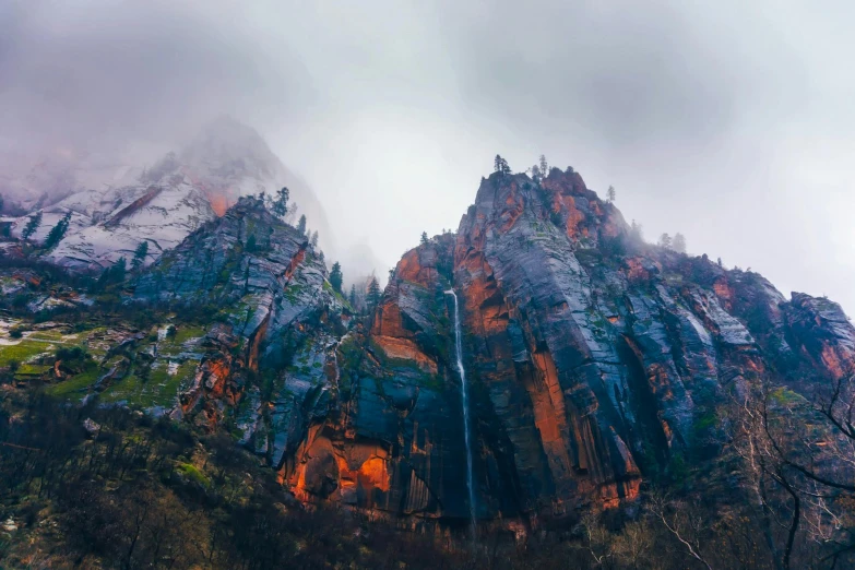 the water is rushing over the mountains and rocks