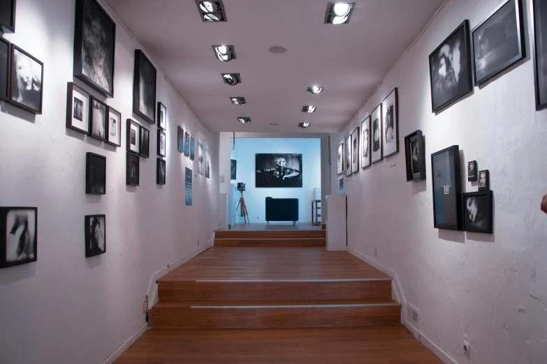 a white hallway with some stairs leading up