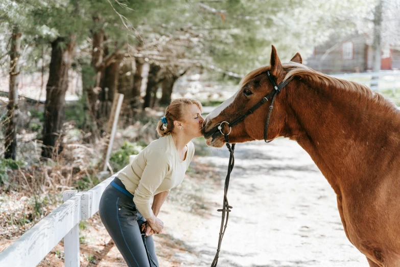 the woman is training her horse on a leash