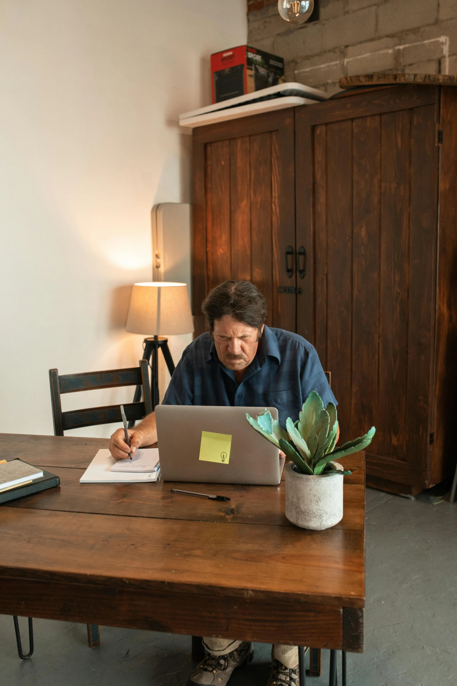 a man on his laptop working at a desk