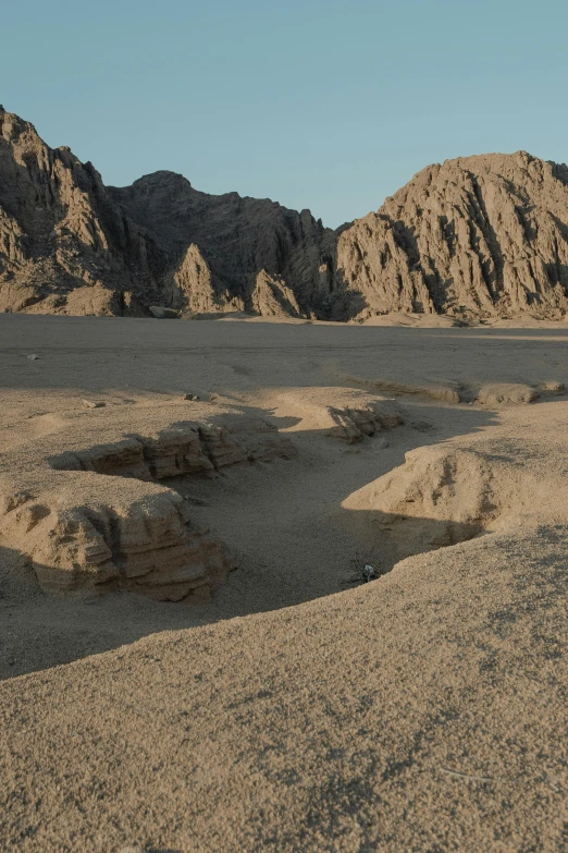 a large mountain range is seen in the distance with no clouds