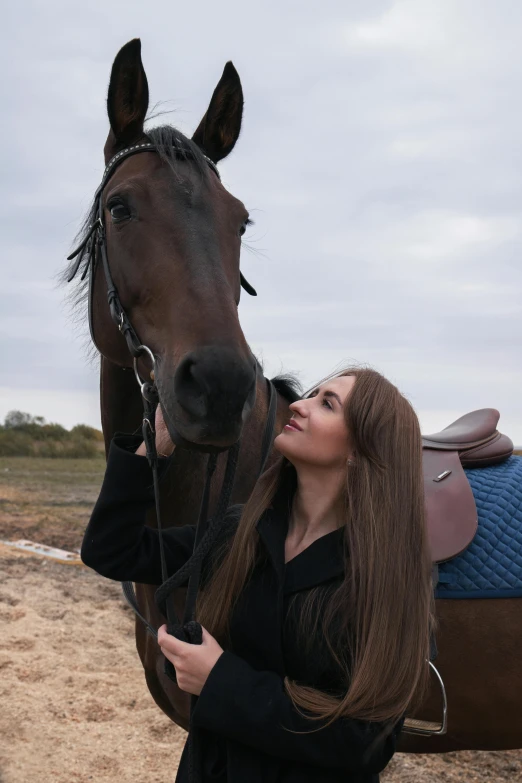 a girl is holding the reigns to a horse