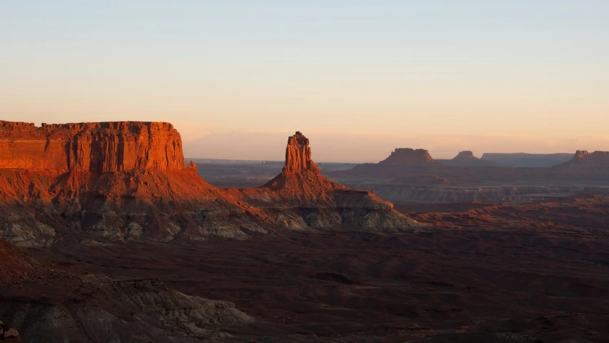 a very tall rock structure in a big desert