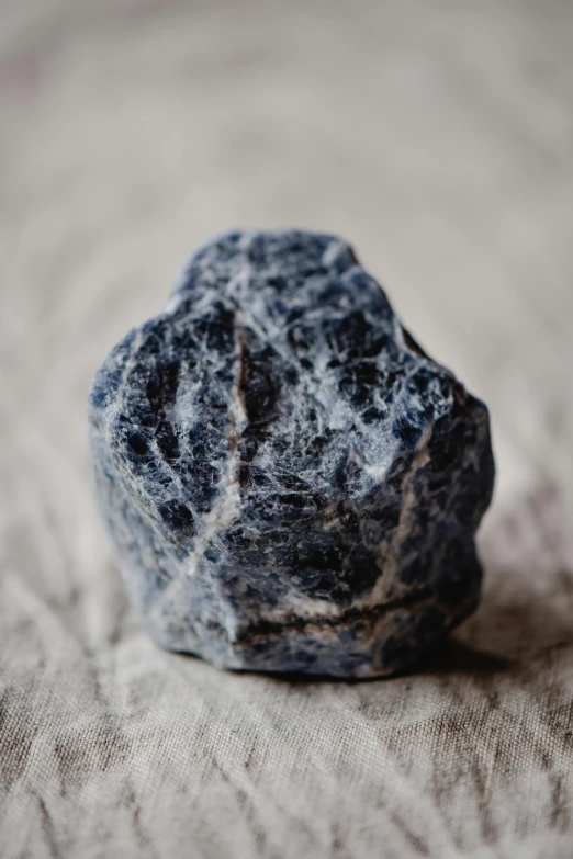 closeup of stone sitting on top of a bed