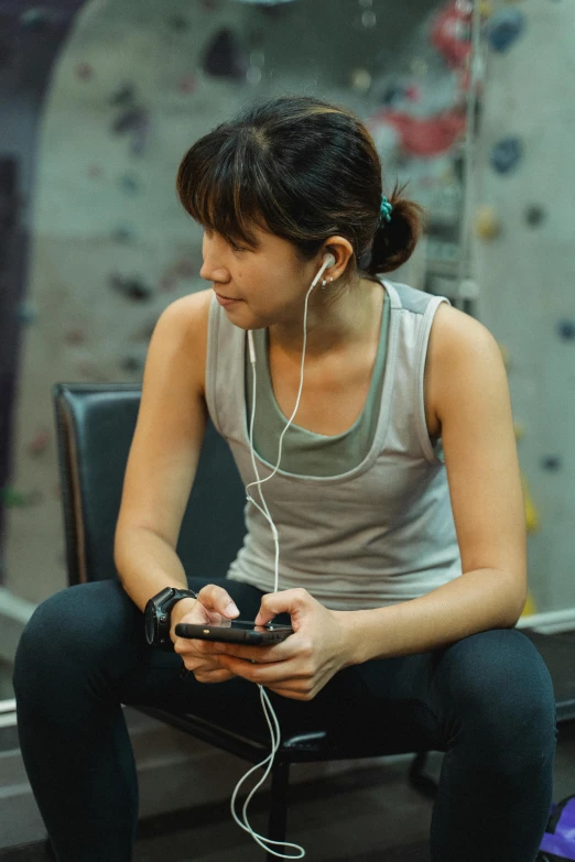 a young woman sitting on the ground with headphones