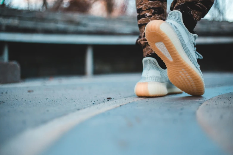 a person with their feet in the air on a street