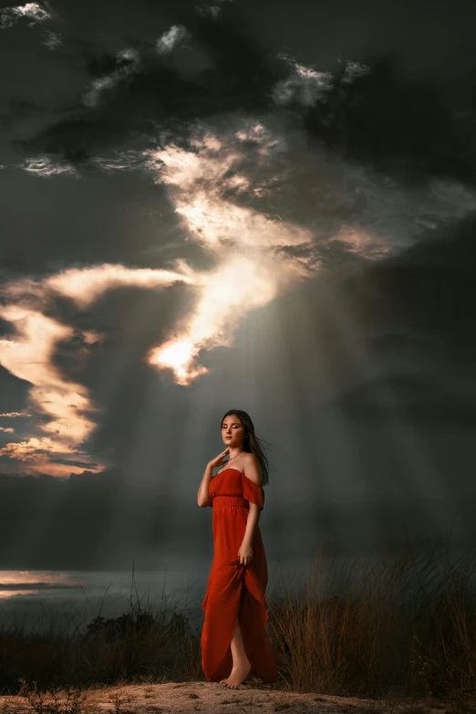 a woman with an orange dress in a dark po