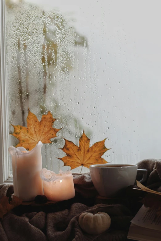 candles on the ground in front of a window