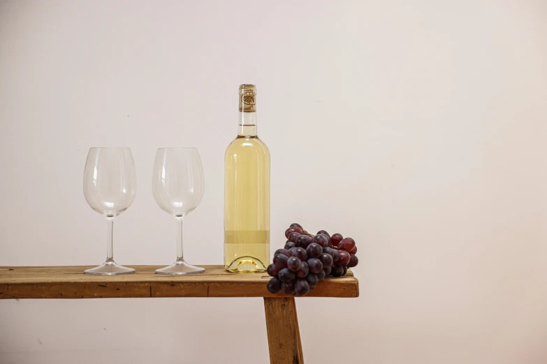an arrangement of fruits and a bottle of wine