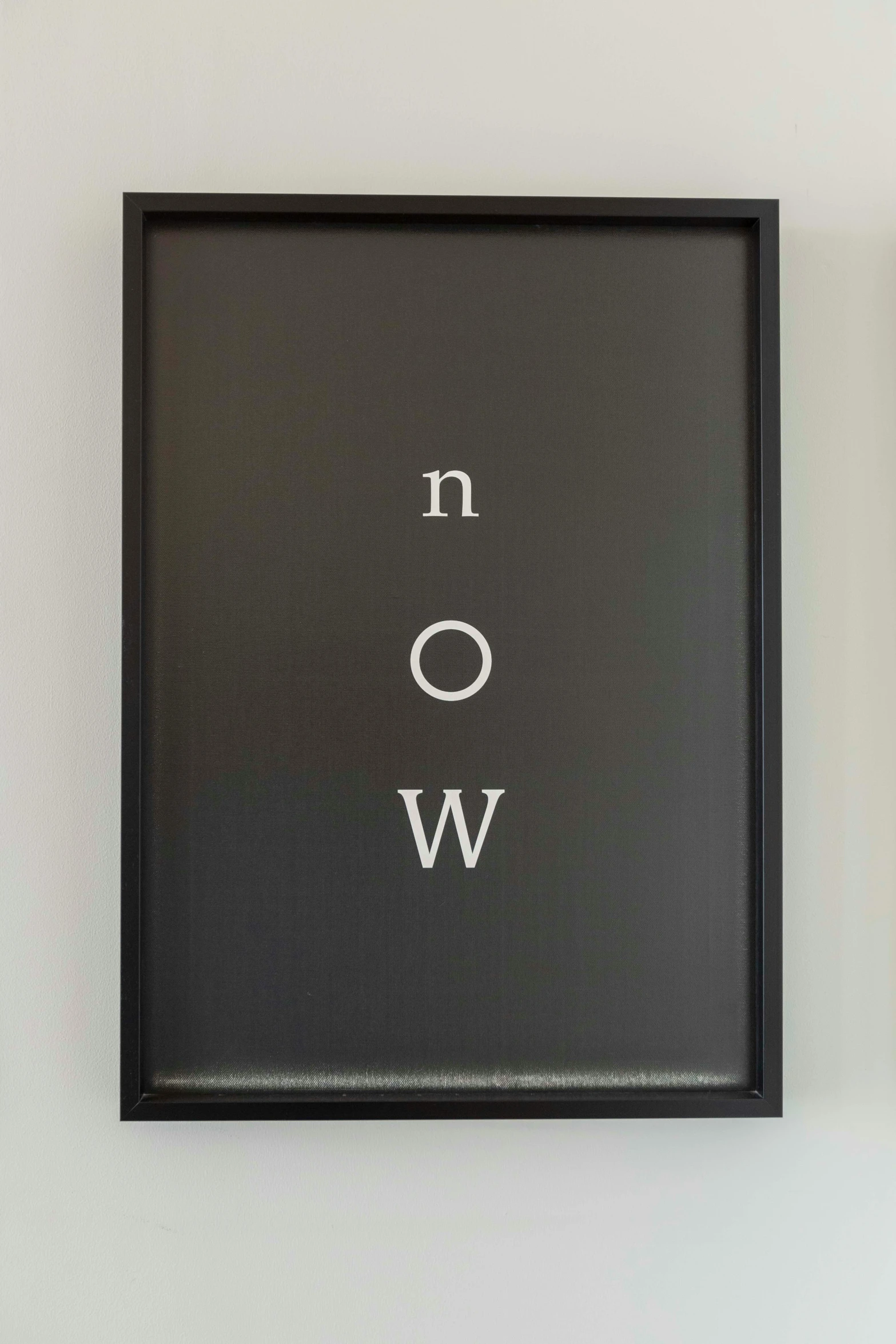 a black frame hanging up on the wall