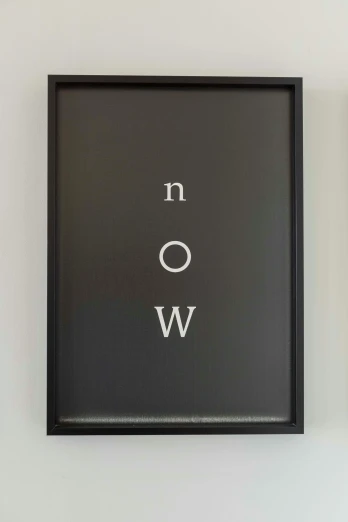 a black frame hanging up on the wall