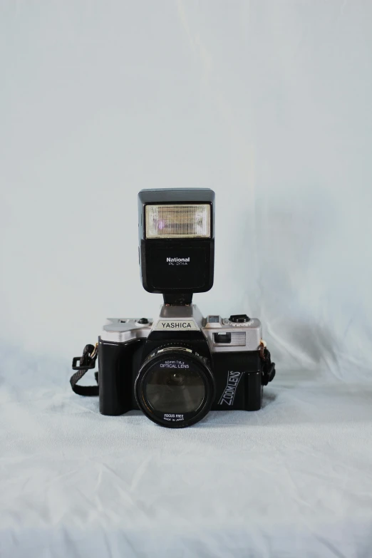 an old fashioned camera with its flash on