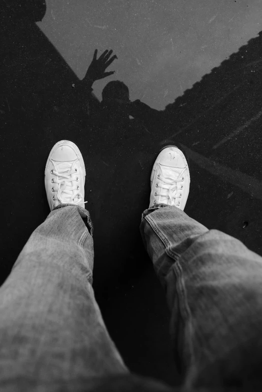 a person standing on a sidewalk next to a house