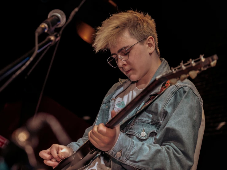 a man playing guitar on stage at a concert