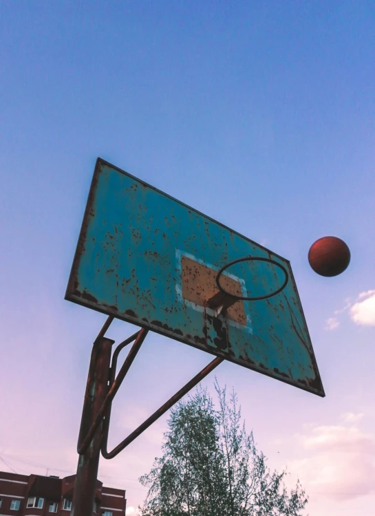 a basketball going into the hoop during the day