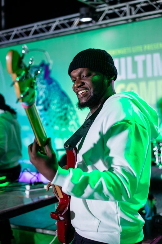 a man that is holding up a guitar