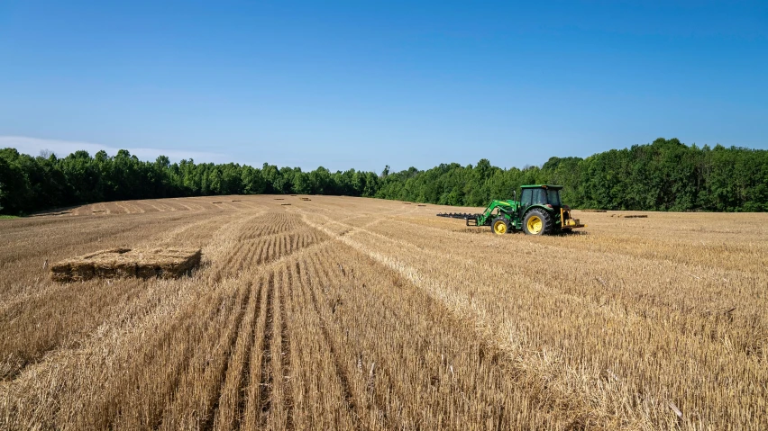 a farm combine that is in the middle of a field