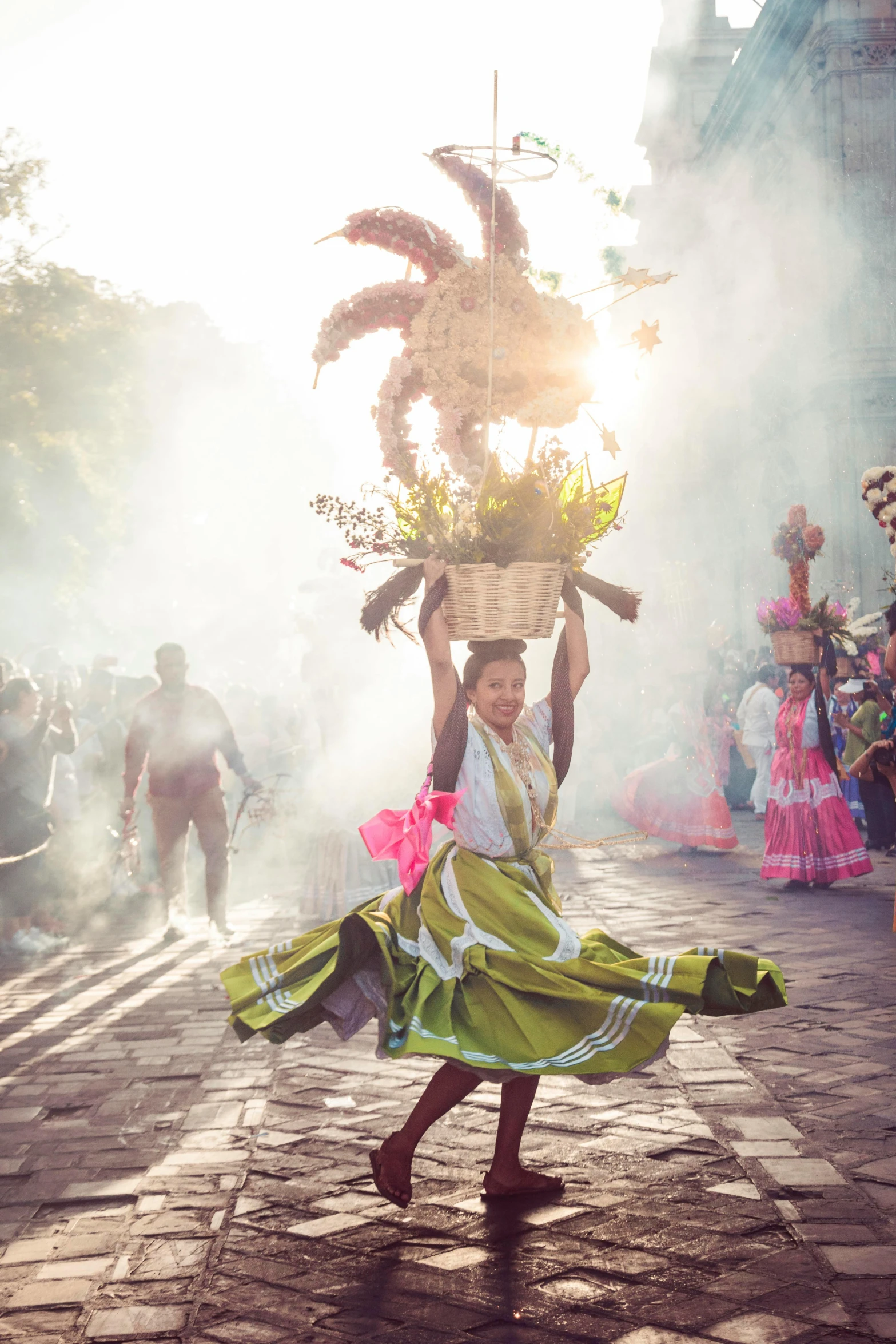 a woman in a brightly colored outfit carries a basket on her head