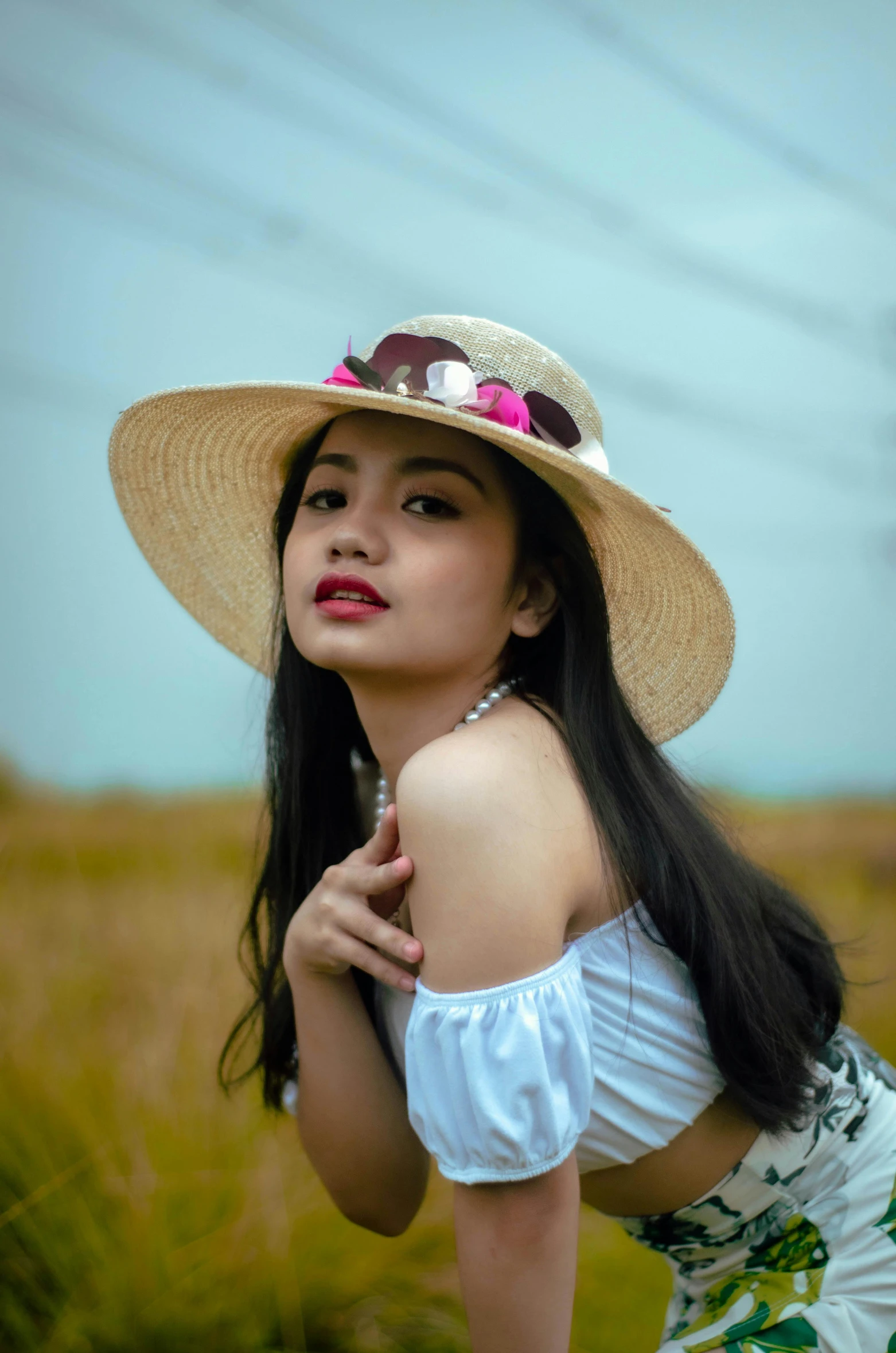 a woman posing for a picture in a field