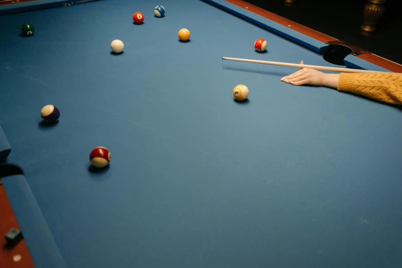 a blue pool table with some balls on it