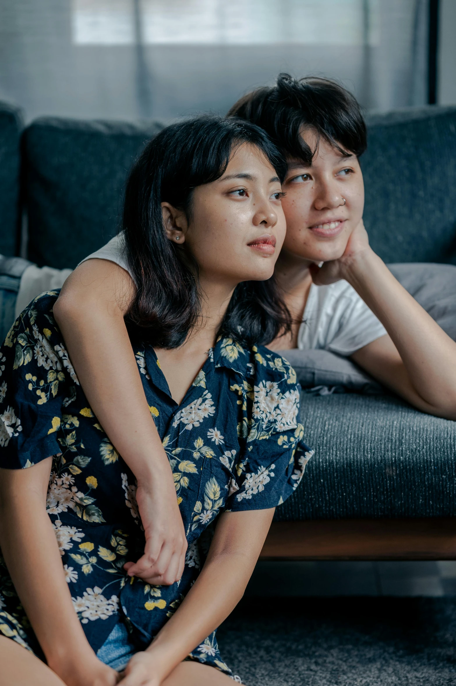 a man and woman sitting on the floor together