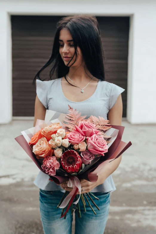 a woman is holding a bouquet of flowers