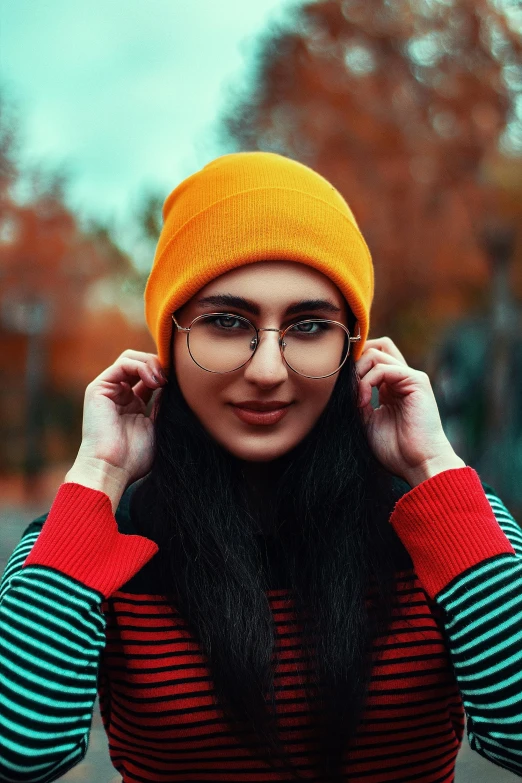 a woman wearing glasses is holding her head up to her face