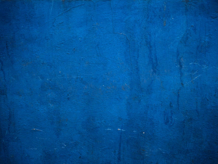 the bright blue wall is painted dark with light rust