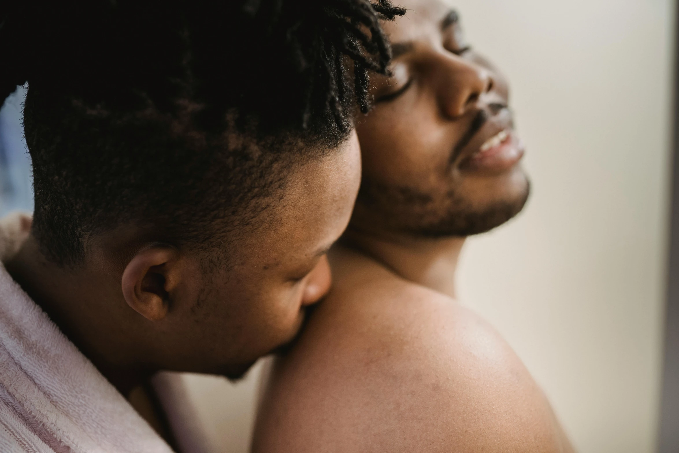 two men that are holding each other near a mirror