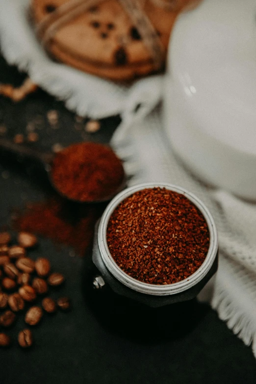 there is a white jar filled with spices