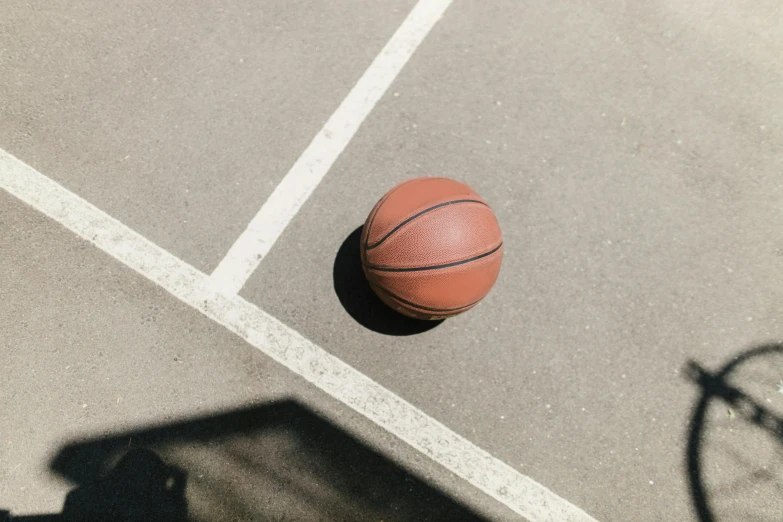 a basketball is on a basketball court next to a bicycle