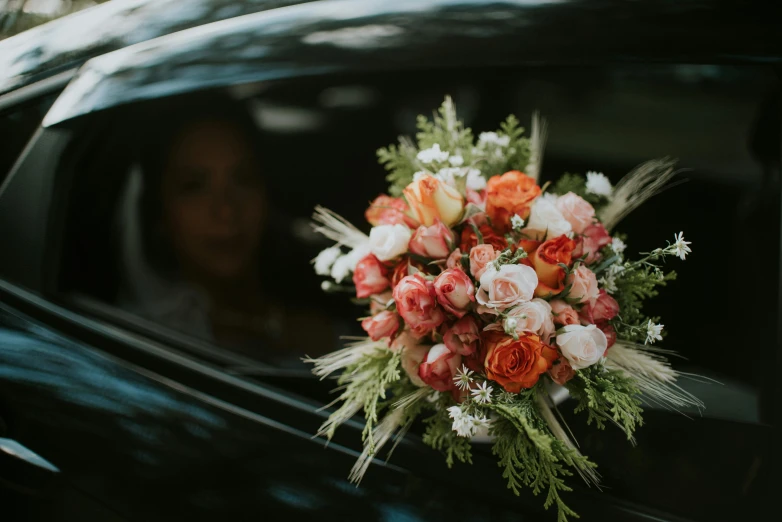 a bouquet of flowers attached to the windshield of a car