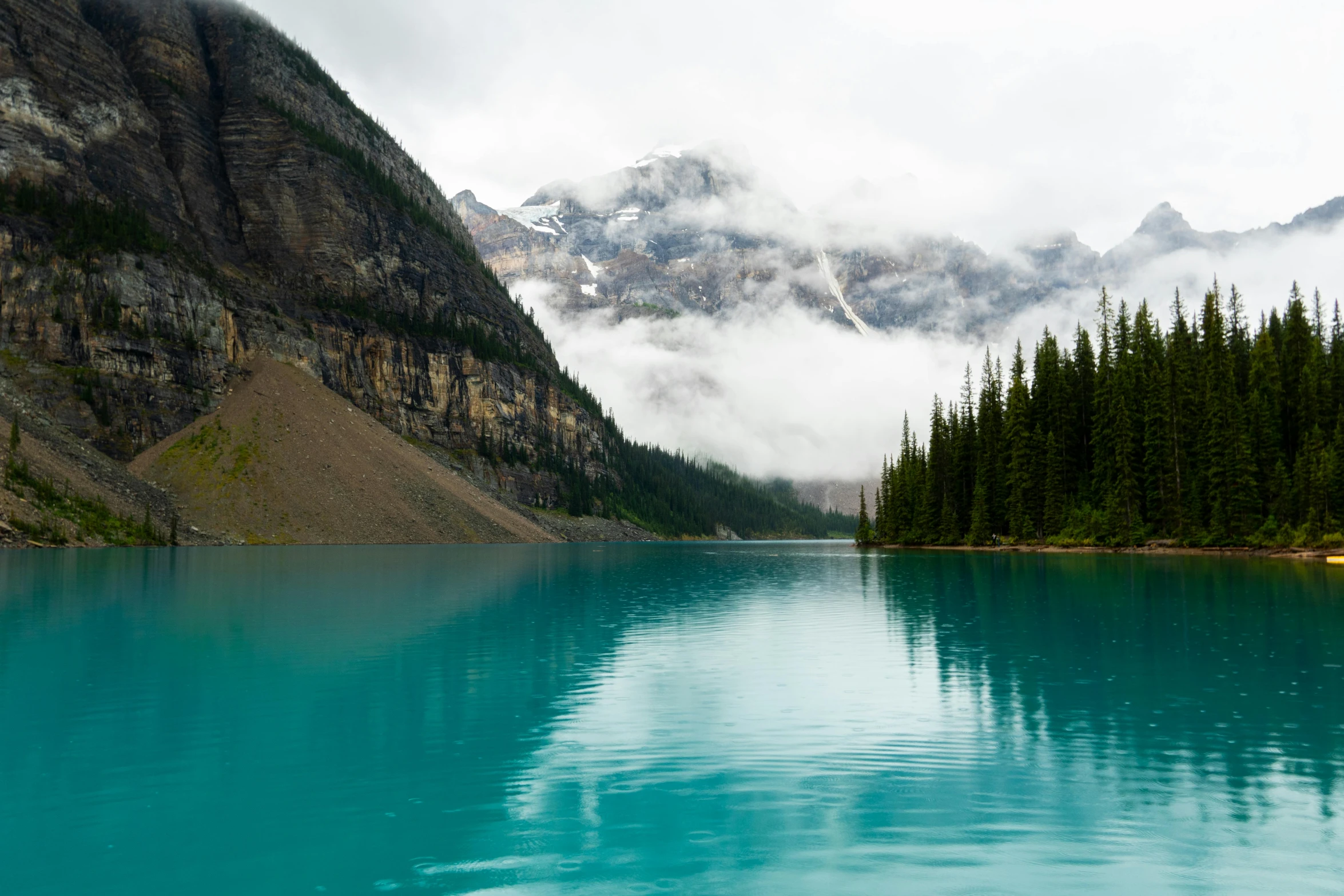 a lake surrounded by mountains and trees