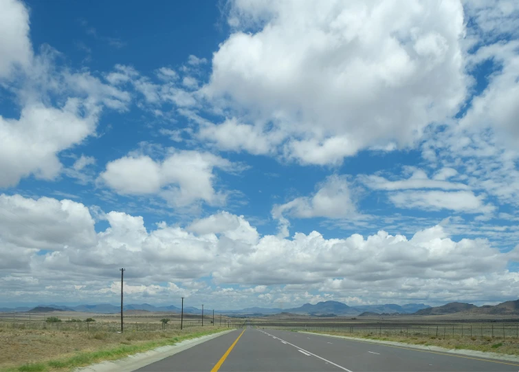 a view from a car driving down an empty road