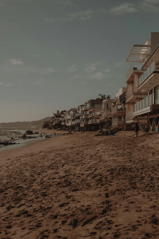 the man is walking on the beach looking into the water