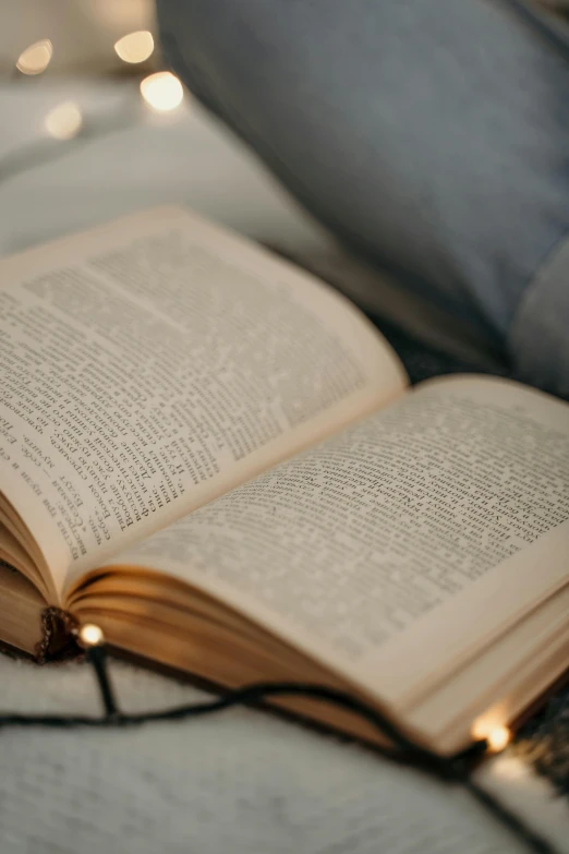 an open book on a bed in the bedroom