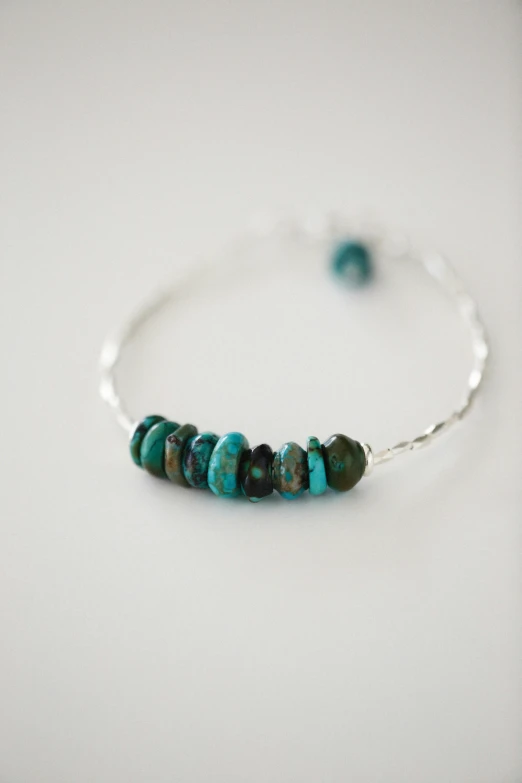 a single celet with blue and green beads