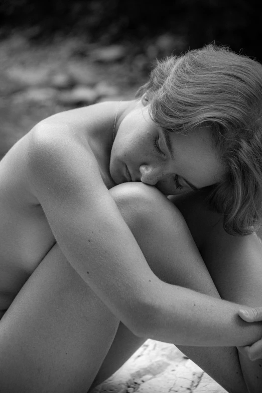 an image of a  woman sitting on the ground