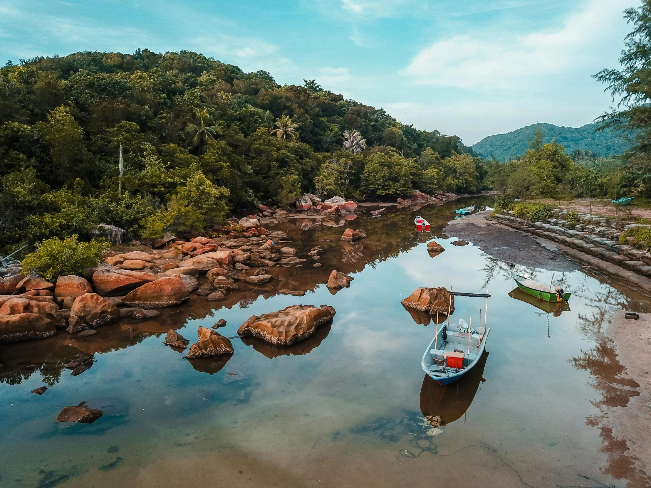 boats on the shore of a small river