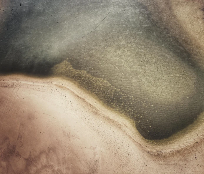 an area of land with dirt and water on the ground