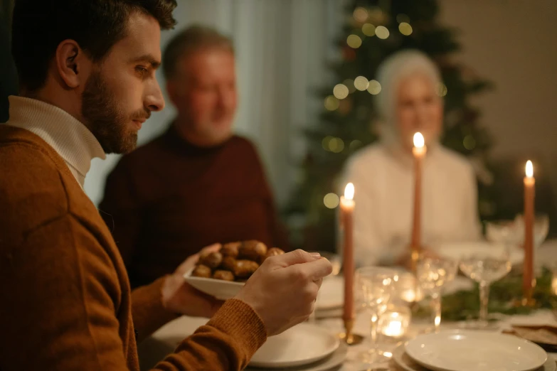 an older gentleman is sharing dinner with his friends