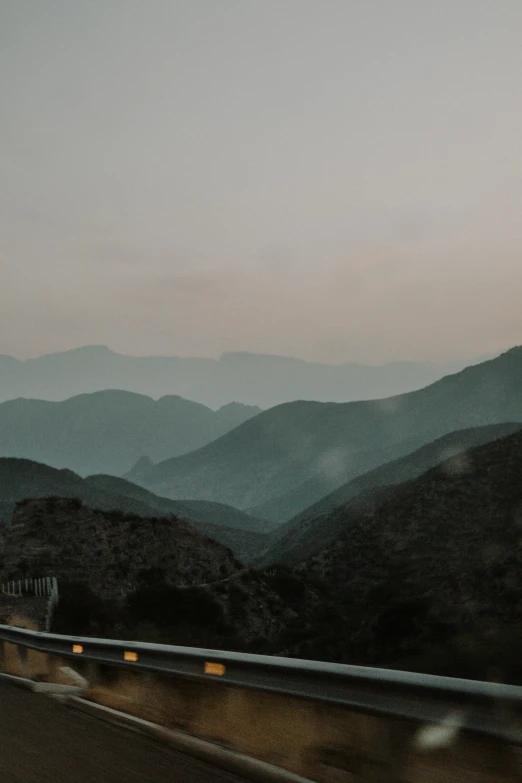 a long, road with mountains in the background