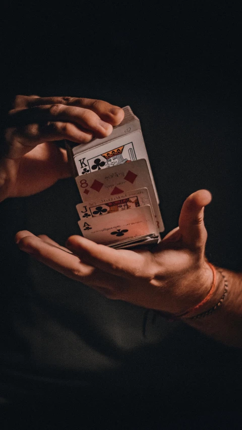 two people holding cards in their hands