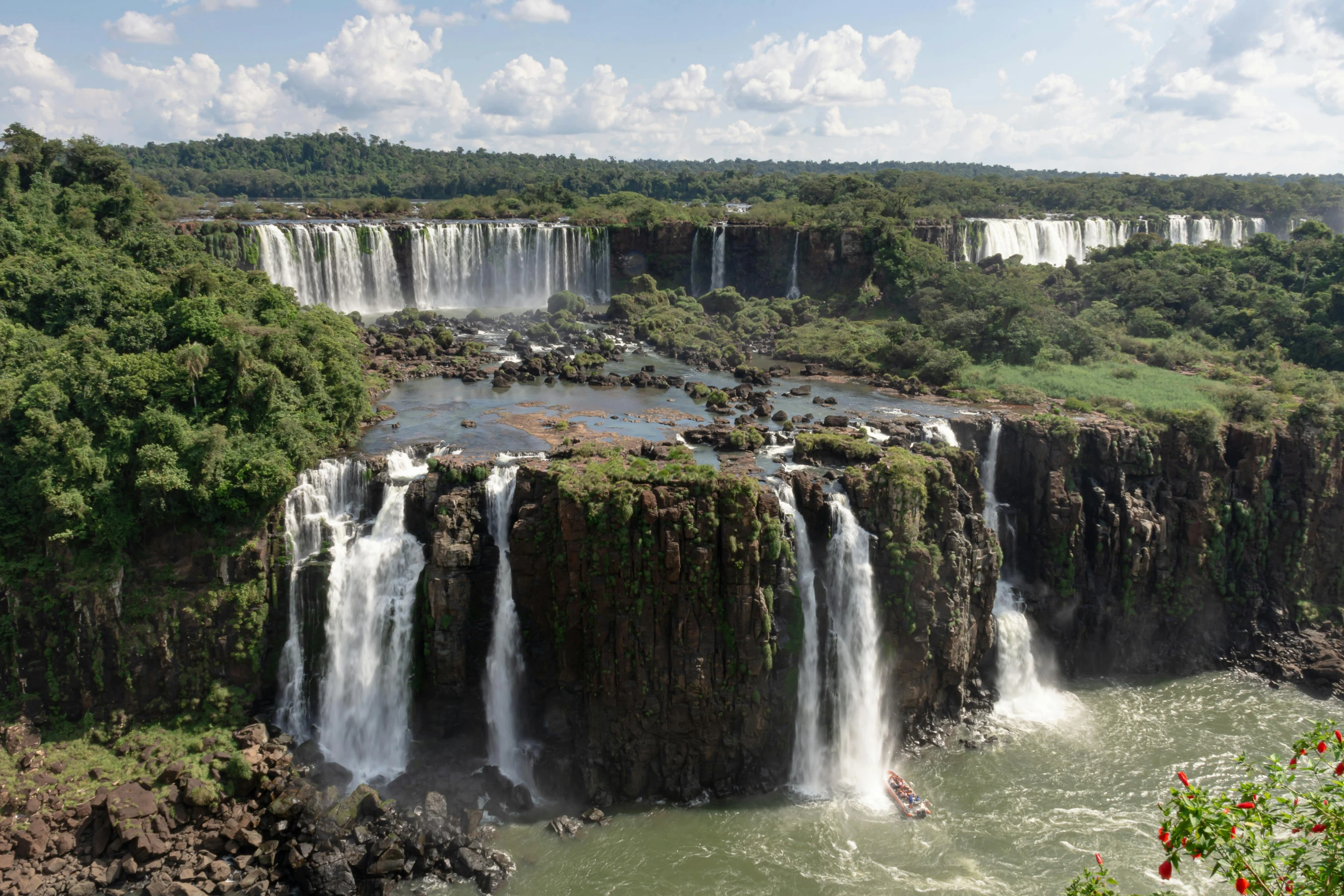 view from the top of a tall waterfall with many waterfalls