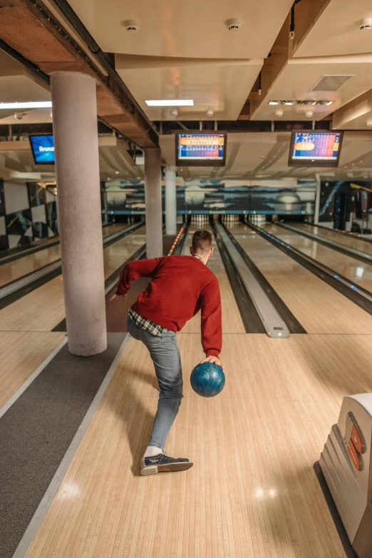 a man standing on top of a bowling ball