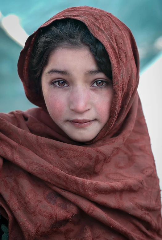 a woman with brown shawl looking straight ahead