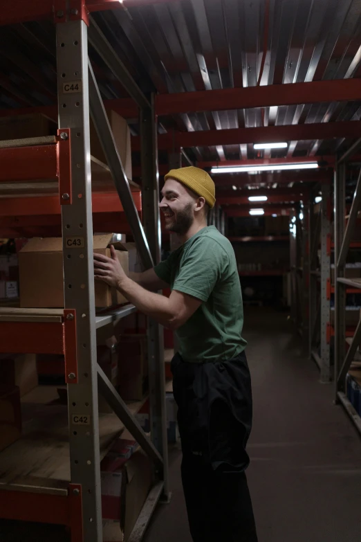 man moving crates and boxes in warehouse setting